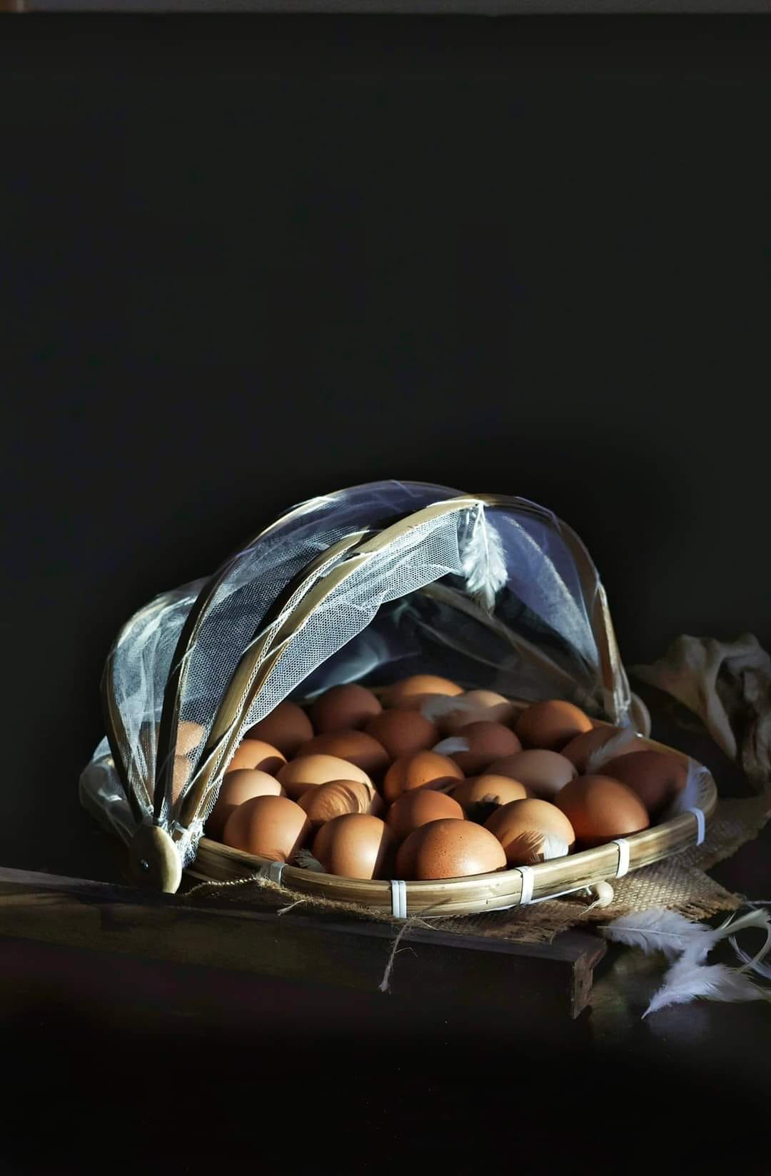 A table with a basket of eggs